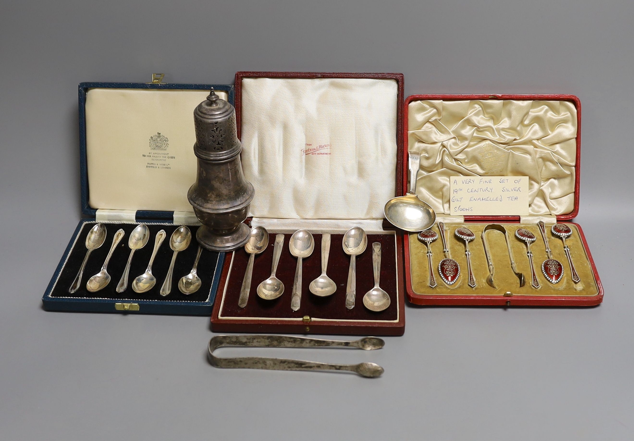 Two cased sets of six silver teaspoons including Art Deco and a cased set of Scandinavian gilt white metal and enamel coffee spoons(a.f.0, a silver sugar caster, pair of silver tongs and a Georgian silver caddy spoon.